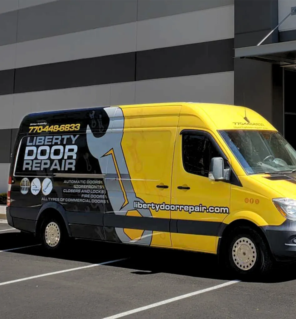 Garage door technician tightening chain drive opener during service in Massachusetts