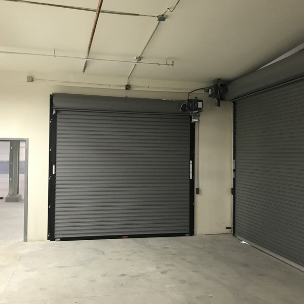 Liberty Door Repair expert inspecting garage door rollers and track system in Massachusetts