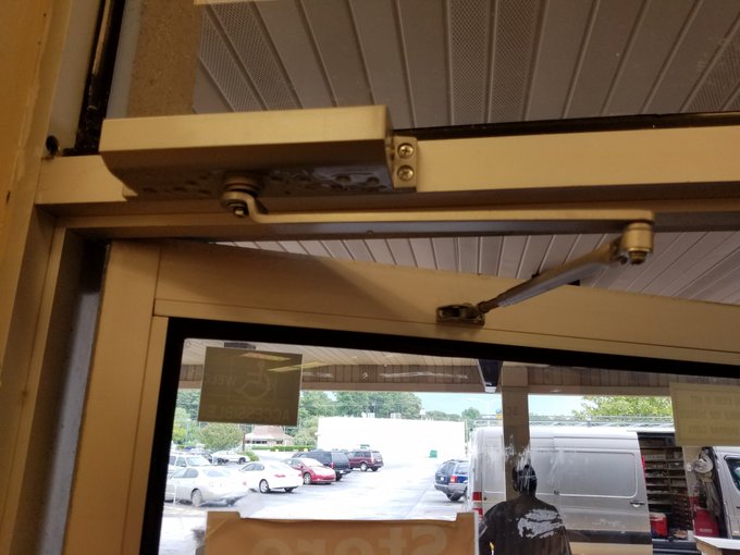 Liberty Door Repair provided door closer services for this broken door closer leaking oil.